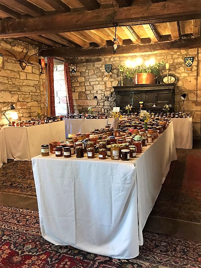 Hundreds of jars of Marmalade on a crisp white cloth in the Great Hall at Dalemain