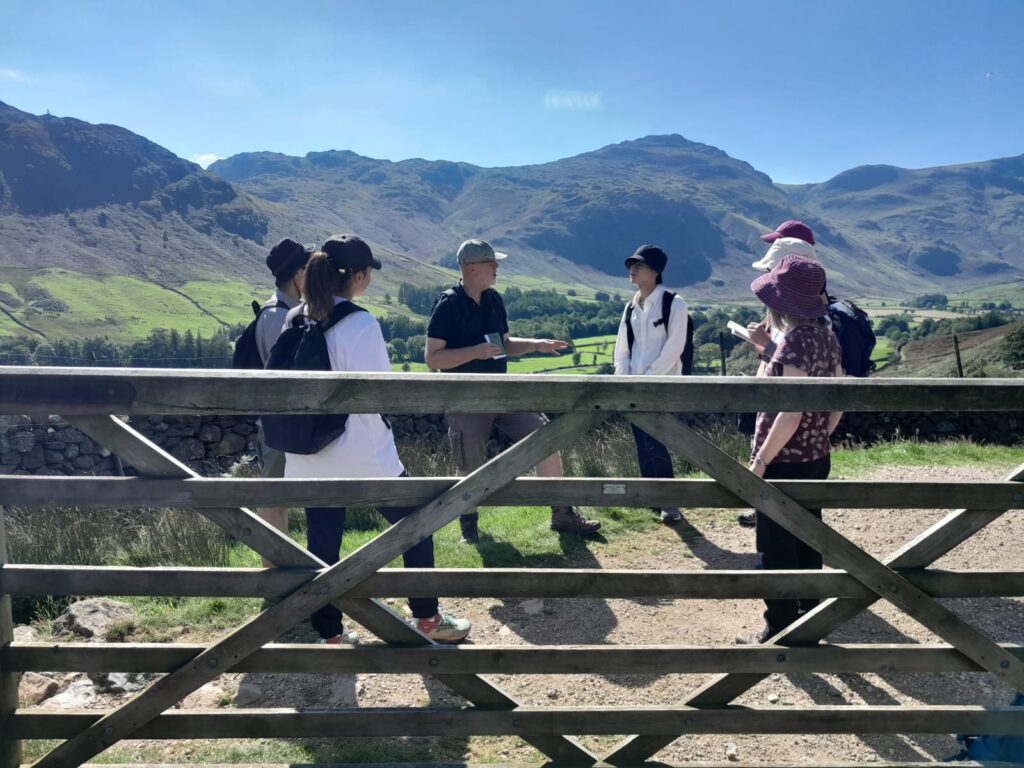 Students listen at a gate in Great Langdale