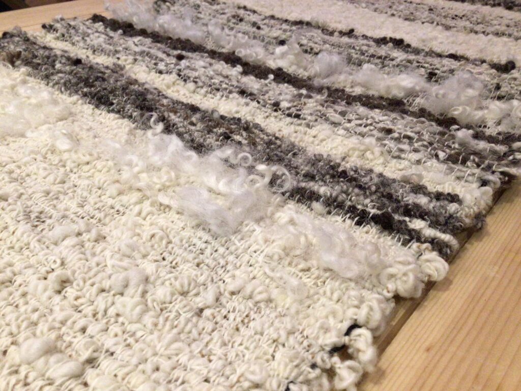 Textured textiles made from undyed handspun yarn woven on a 4-shaft loom